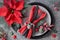 Christmas table setting on grey granite, plates, crockery, red napkin decorated with berries and poinsettia