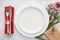 Christmas table setting with plates, red napkin, fork and knife