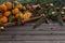 Christmas tangerines with leaves on a wooden tray with spices star anise and cinnamon surrounded by fir branches and Christmas t