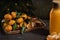 Christmas tangerines with leaves on a wooden tray with spices star anise and cinnamon and tangerine juice on the background of a