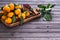 Christmas tangerines with leaves on a wooden tray with spices star anise and cinnamon on a wooden table