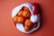 Christmas tangerines in a Santa hat on an orange background, Christmas fruits, festive symbol