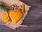 Christmas tasty cookies lie on a napkin on a wooden background. Around the cookies lies dried orange, cinnamon and a spruce branch