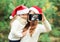 Christmas and technology concept - mother and child taking picture self portrait on smartphone together