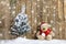 Christmas teddy bear sitting in the snow