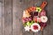 Christmas theme charcuterie board. Overhead view against dark wood.