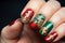 Christmas themed green, red and gold colored nail polish design og woman\\\'s fingernails