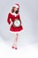 Christmas Time Concept. Full length Portrait of Smiling Gleeful Red Haired Santa Helper Posing with Big Round Clock