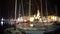 Christmas time in cozy town, view on yachts and boats moored in harbor at night