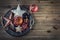 Christmas time. Wrought metal plate filled with various Christmas decorations. Christmas stars, Jingle bells in various positions.