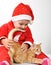 Christmas toddler child plays with a cat