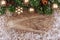 Christmas top border with gold ornaments, branches and snow