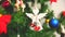 Christmas toy angel on New Year tree. Holidays decoration, lights and garland.