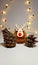 Christmas toy deer next to fir cones
