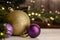 Christmas toy golden ball next to a purple