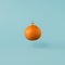 Christmas toy made from orange tangerine fruit. Minimal New Years concept. Levitation