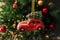 Christmas toy red car on a New Year tree. Christmas composition