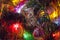 Christmas toys on christmas tree with luminous festoon closeup. New Year`s holiday background.