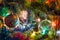 Christmas toys on christmas tree with luminous festoon closeup. New Year`s holiday background.