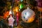 Christmas toys on christmas tree with luminous festoon closeup. New Year`s holiday background.