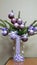 Christmas toys on fir branches. Homemade purple Christmas decorations on spruce branches