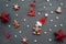 Christmas toys and gingerbread in the form of a traditional ginger man with a Santa Claus hat on a gray background.