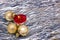 Christmas toys golden balls, burning red candle on silver background.