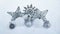 Christmas toys lie on the snow. Balls, star, snowflake. Gold and silver Christmas decorations