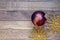 Christmas toys: one red christmas ball and two golden snowflakes on brown wooden background. New Year concept, composition. Retro