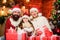 Christmas traditions concept. Christmas is the time to please. Joyful people. Lovely daughter with parents. Father Santa