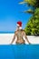 Christmas travel beach holidays in Maldives. Christmas Maldives beach and Santa Claus woman. Bikini girl wearing santa hat