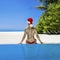 Christmas travel beach holidays in Maldives. Christmas Maldives beach and Santa Claus woman. Bikini girl wearing santa hat