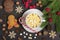 Christmas treats - gingerbread and hot chocolate with marshmallows, cinnamon, cloves on a wooden table decorated with Christmas de