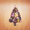 Christmas tree arrange from shiny sequins on wooden background..