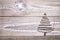 Christmas tree arranged from sticks on wooden sparkly grey background