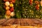 Christmas tree background with decoration and blurred light bokeh with empty dark wooden deck table for product montage.