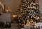 Christmas tree with balls, garland. downstairs gifts. room in warm colors. horizontal photo of home design