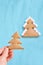 Christmas tree biscuits. White small marshmallow. Blue background