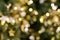 Christmas tree bokeh light in green yellow golden color, holiday abstract background, blur defocused