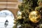 Christmas tree branch decorated with baubles, balls on architectural landmark background. Festive outdoor decorative christmas