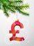 Christmas tree branch with decorative pound sterling symbol