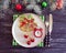 Christmas tree branch, plate, alarm clock seasonal festive on a wooden background