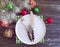 Christmas tree branch, plate, fork celebration seasonal vintage knife frost decorative on a wooden background