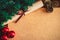 Christmas tree branch, three red balls, cones and scroll paper with a bow on the table copy space xmas background