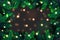 Christmas tree branches background. Festive Xmas border of green branch of pine with sparkling lights garland, vector illustration