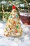 Christmas tree cake in festive decoration.  Cupcake in form of Christmas tree with cup of tea
