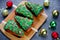 Christmas tree cakes, festive pie pieces decorated with green frosting and sprinkles