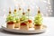 Christmas tree canape with cucumber slice, salmon pate and red caviar