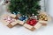 Christmas tree and cardboard boxes full of Christmas balls, isolated on white floor, preparation concept