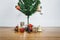 Christmas tree with Christmas presents and decorations on wooden floor, in living room